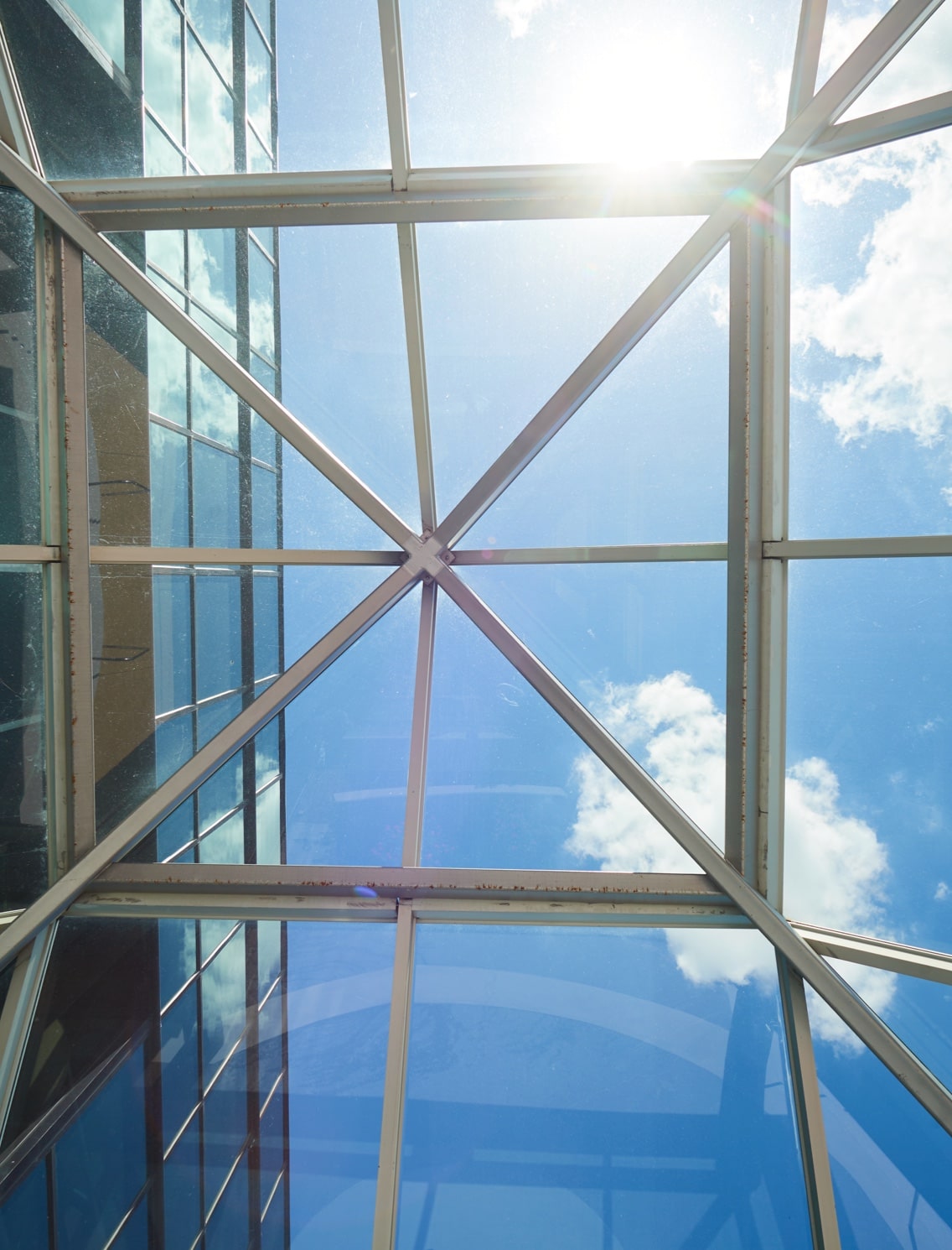View of sunny sky through the glass roof
